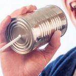 man talking into a tin can